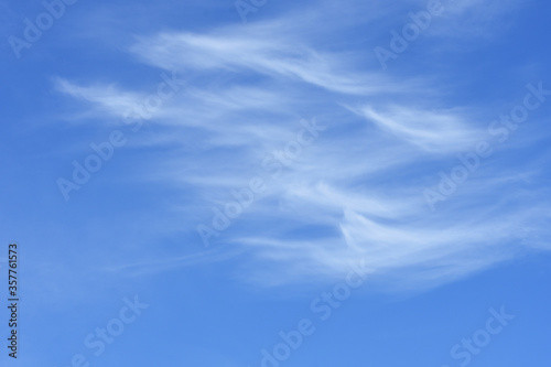 Cirrostratus cloud in high blue sky.  A fluctuation weather make a dreamy and imaginative cloudscape. Soft and flow of cloud in vast nature background. 