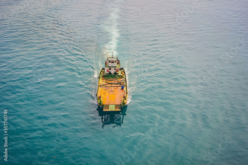Aerial drone photo of small ferry cruising open ocean sea © galitskaya