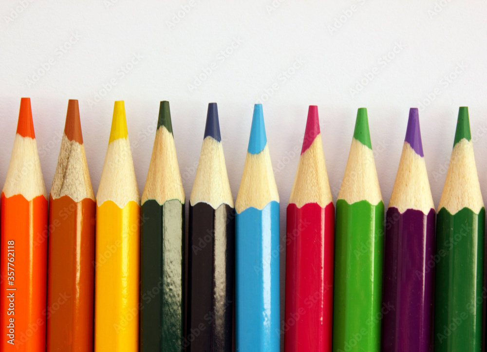 Colored pencils on a white background. Lots of different colored pencils. Colored pencil. Pencils are sharp. Pencils lie on the down. Beautiful background. Close-up. Copy space. Background. Flat lay Colored pencils on a white background. Lots of different colored pencils. Colored pencil. Pencils are sharp. Pencils lie on the down. Beautiful background. Close-up. Copy space. Background. Flat lay