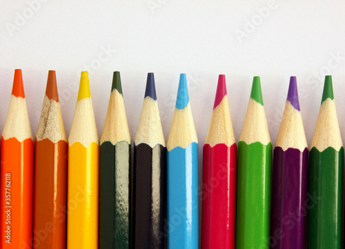 Colored pencils on a white background. Lots of different colored pencils. Colored pencil. Pencils are sharp. Pencils lie on the down. Beautiful background. Close-up. Copy space. Background. Flat lay