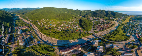 Agoy river valley in a small resort village in the Caucasus mountains on the Black Sea coast near the Dzhubga-Sochi road - aerial panorama of a summer sunny day