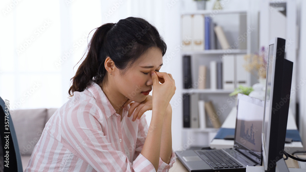 korean office lady getting tired eyes from staring at screen for long period. asian woman with asthenopia is pressing acupuncture point and struggling to focus her vision. health and eye care concept korean office lady getting tired eyes from staring at screen for long period. asian woman with asthenopia is pressing acupuncture point and struggling to focus her vision. health and eye care concept
