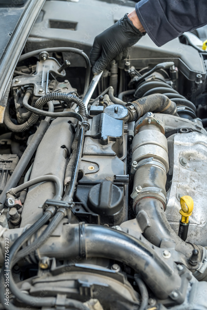 auto mechanic working with wrench key in car repairing, close-up auto mechanic working with wrench key in car repairing, close-up