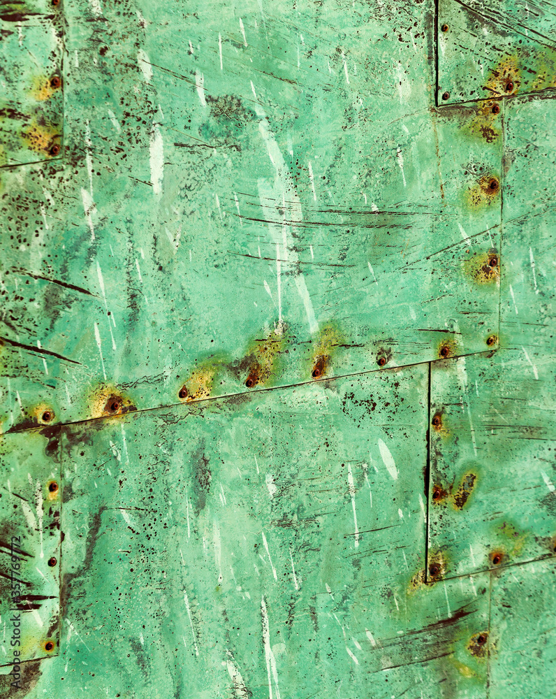 Beautiful abstract patterns and texture of rivted panels of exposed copper sheet with green aged patina Beautiful abstract patterns and texture of rivted panels of exposed copper sheet with green aged patina