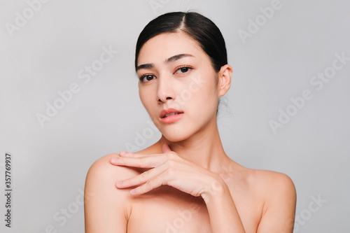 Face of Young beautiful asian woman with clean, fresh and bright skin, Happiness and cheerful with positive emotional,isolated on gray background,Beauty Cosmetics and Facial treatment Concept