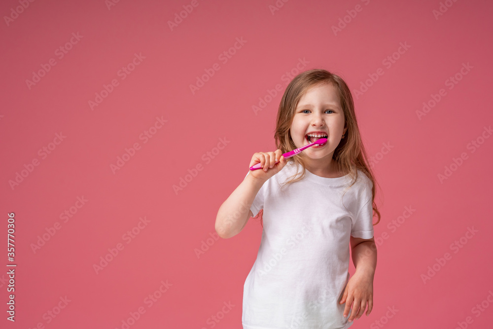 Cheerful little girl 4 years old, Caucasian, smiling, brushing her teeth Cheerful little girl 4 years old, Caucasian, smiling, brushing her teeth