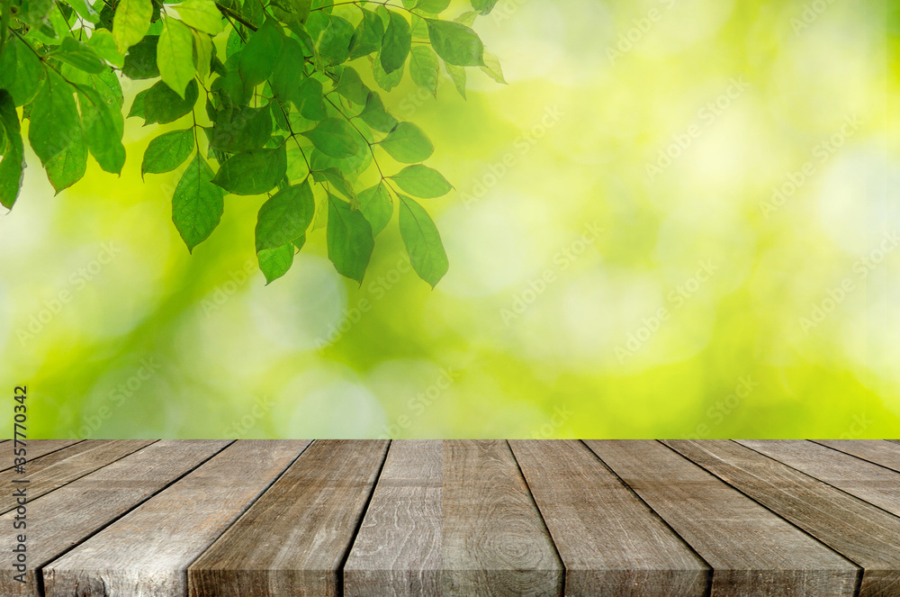 wood table top and Abstract blur green leaves background wood table top and Abstract blur green leaves background