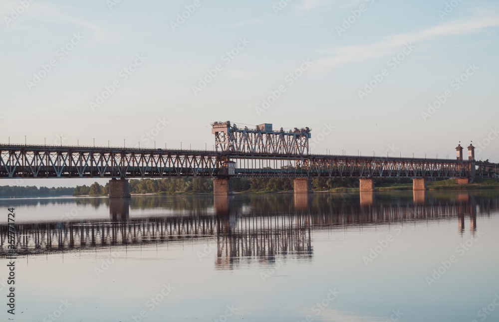 Metal structure railway bridge over the river. Old river bridge.