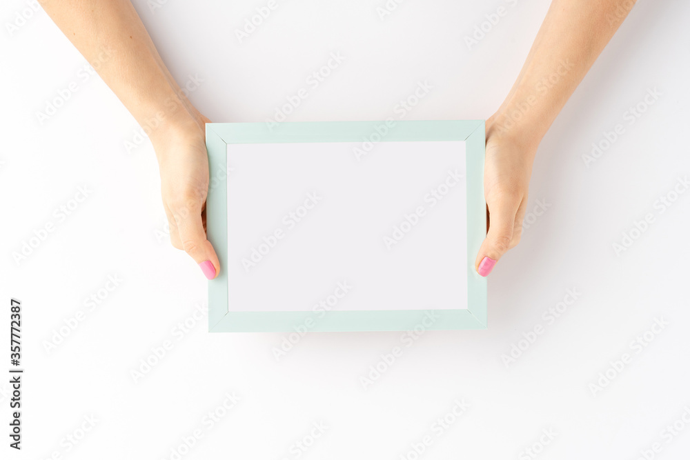 Woman’s hands showing blank photo frame isolated on white background. Mockup Woman’s hands showing blank photo frame isolated on white background. Mockup