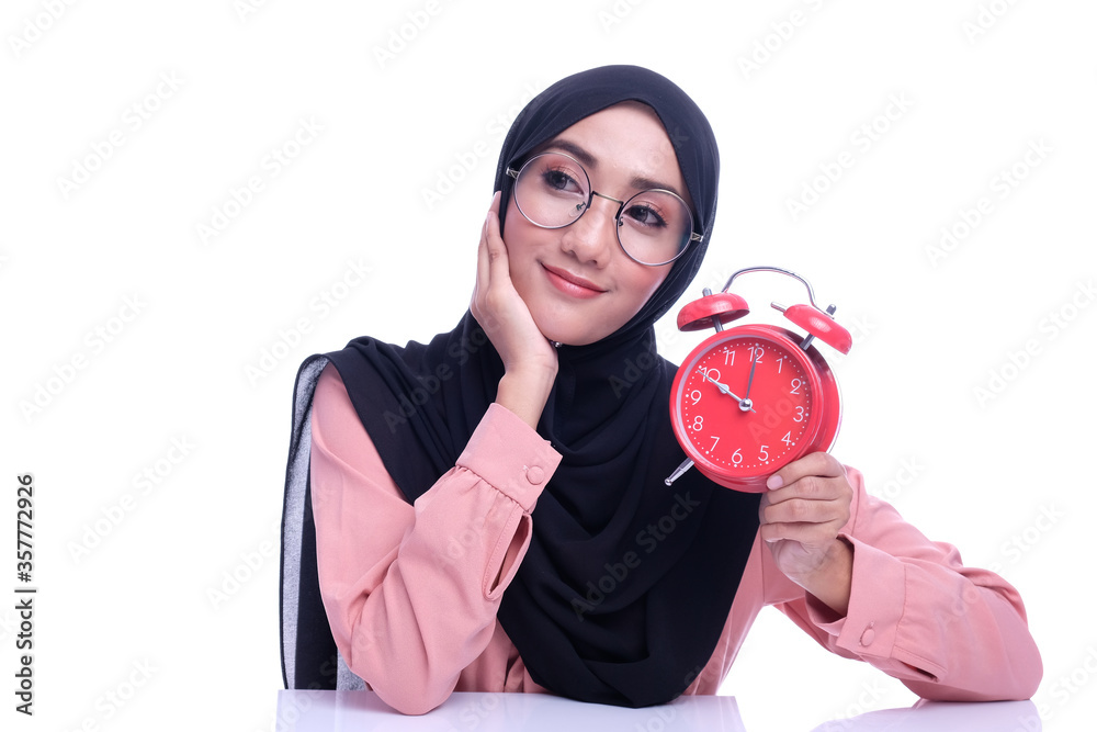 Muslim woman hold alarm clock with deference expression face with deference time conceptual Muslim woman hold alarm clock with deference expression face with deference time conceptual