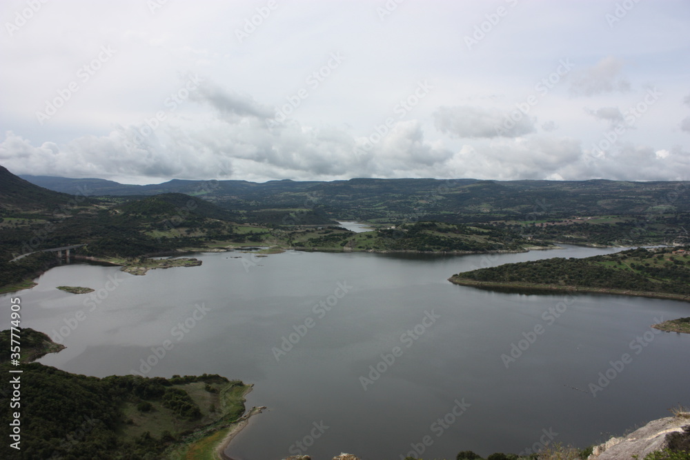 Temo lake in Sardinia, Monteleone Rocca Doria, aerial view, cloudy sky