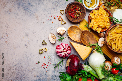 Cooking pasta ingredients background. Raw ingredients for the cooking of Italian pasta, top view, copy space.