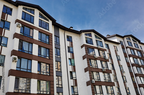 Modern apartment buildings on a sunny day with a blue sky. Facade of a modern European apartment building