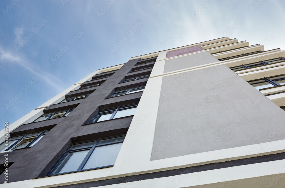 Modern apartment buildings on a sunny day with a blue sky. Facade of a modern European apartment building Modern apartment buildings on a sunny day with a blue sky. Facade of a modern European apartment building
