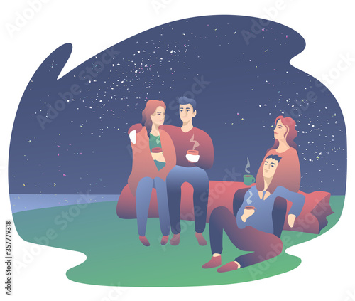 Young guys are sitting in ancient times and drinking hot drinks. Camping with friends, couples hugging under the starry sky. Camping concept.