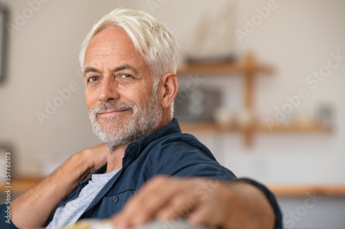 Portrait of retired satisfied man at home