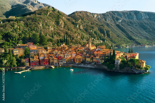 Fototapeta Naklejka Na Ścianę i Meble -  Aerial view of Varena old town by Lake Como, Italy, Europe. Famous travel destination in Lombardy. Mountains in background. Sunny weather.