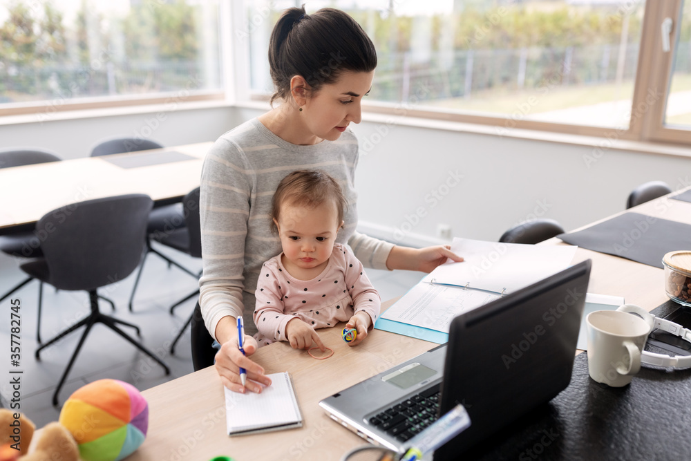 remote job, multi-tasking and family concept - mother with baby working at home office remote job, multi-tasking and family concept - mother with baby working at home office