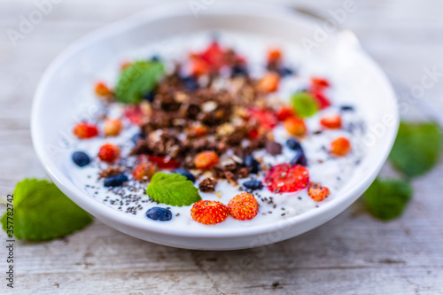 A bowl of delicious yogurt with grains and fresh berry fruit. Weight loss and healthy diet.