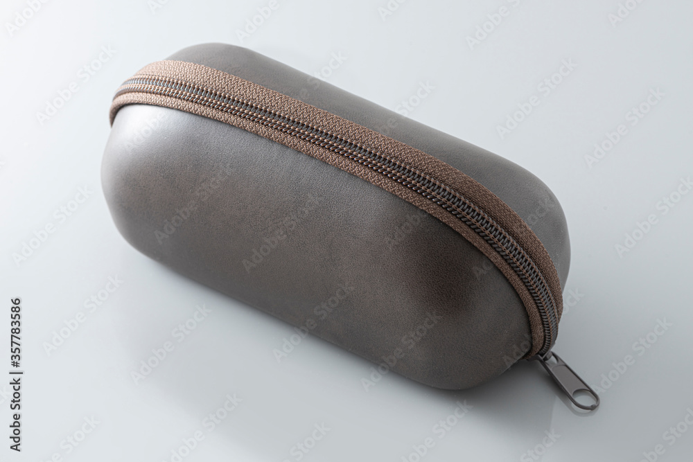 Brown leather protection case box for glasses isolated over the gray background. Brown leather protection case box for glasses isolated over the gray background.