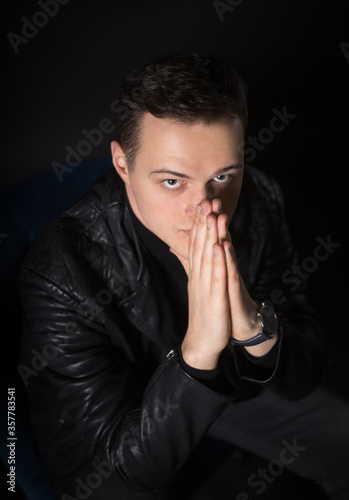 Portrait of an attractive man in the studio on a black background.