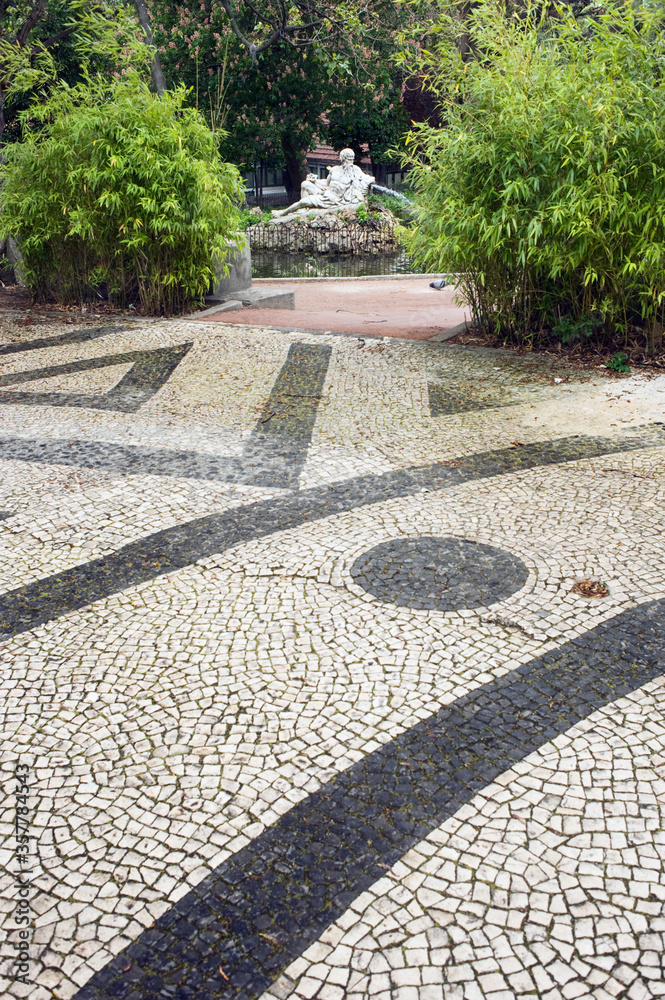 Obraz premium traditional black and white pavement named calcada in the park of Estrela, Lisbon