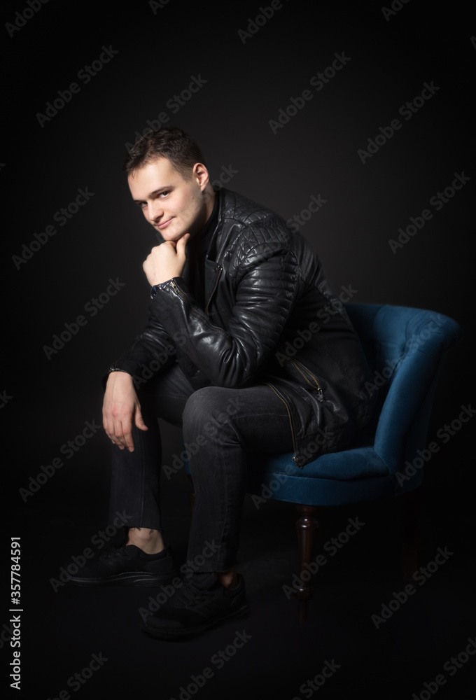 Portrait of an attractive man in the studio on a black background. Portrait of an attractive man in the studio on a black background.