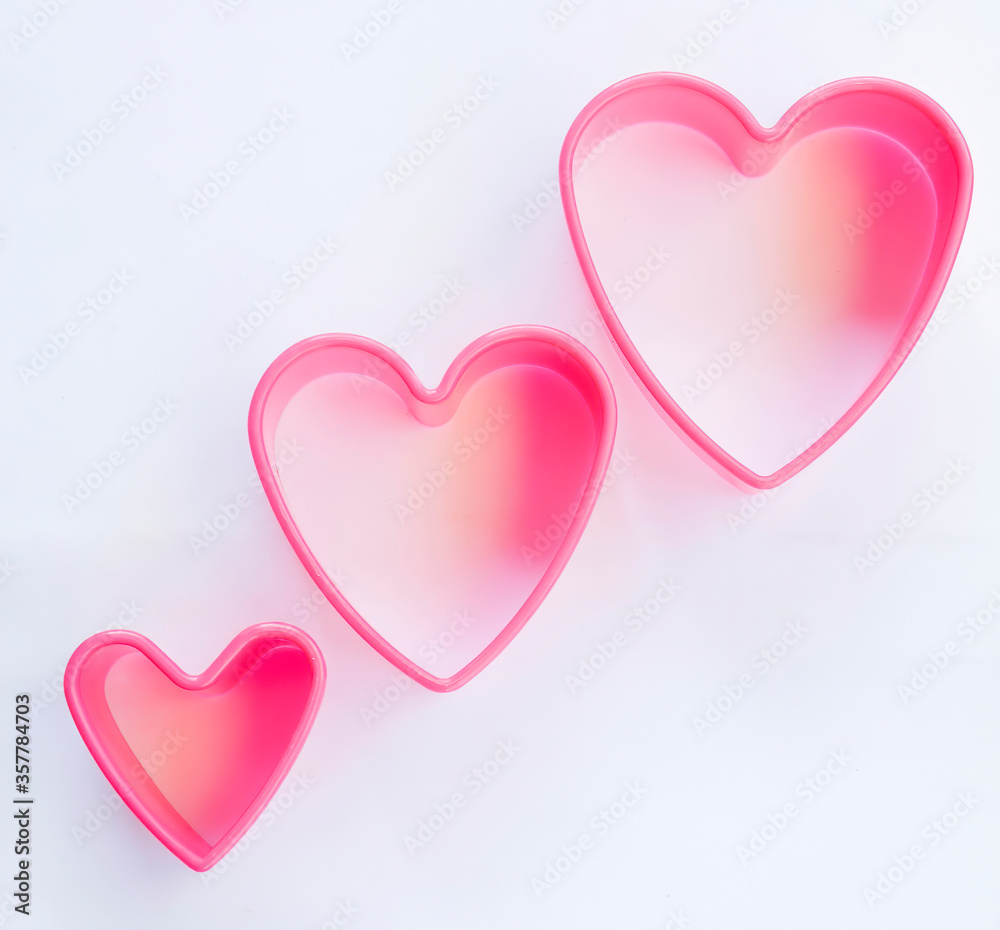 three pink heart on white background