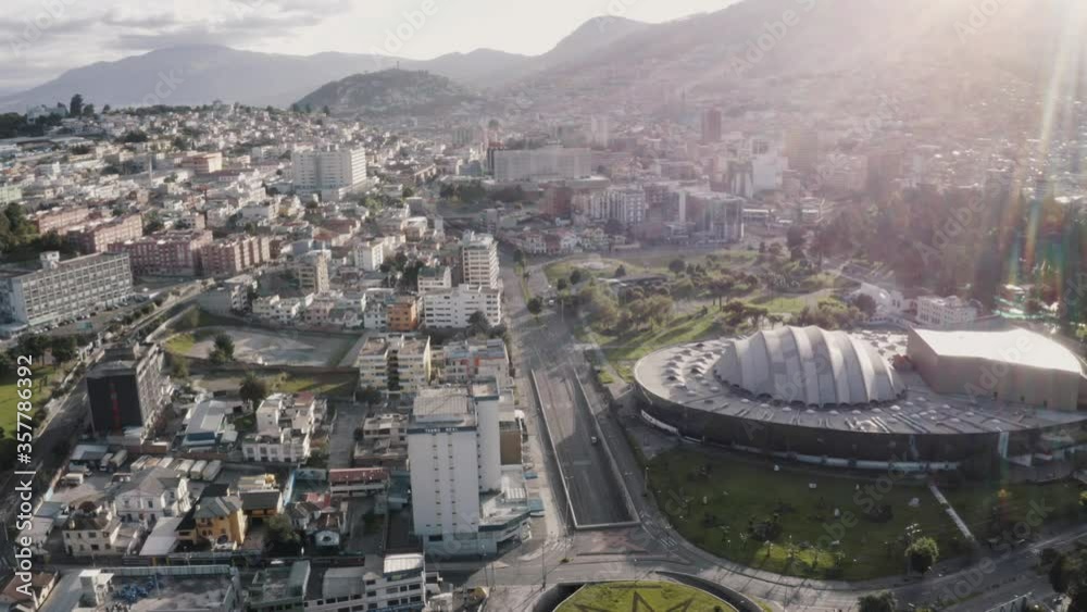 Drone shot of the city of Quito, Ecuador during quarantine. Overlooking avenue twelve of October and Casa de la Cultura. The Virgin of Quito and Panecillo in the far back. Some cars are transiting. Drone shot of the city of Quito, Ecuador during quarantine. Overlooking avenue twelve of October and Casa de la Cultura. The Virgin of Quito and Panecillo in the far back. Some cars are transiting.