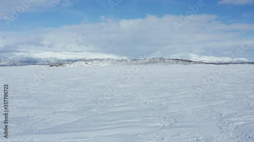 Flying over the frozen Torneträsk Lake. Swedish Lapland. Abisko National Park.