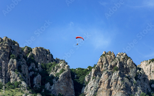 a pair of gliders flying over the mountains 2