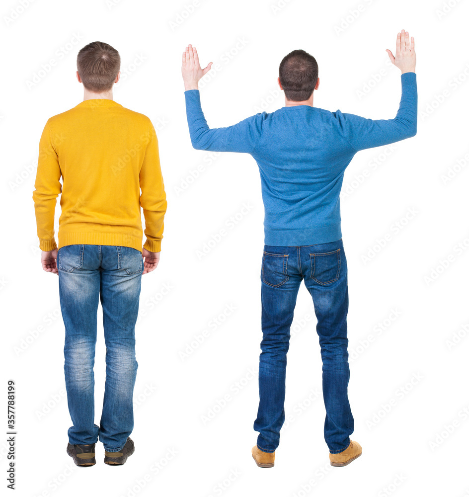 Back view of two man in sweater pointing. Back view of two man in sweater pointing.