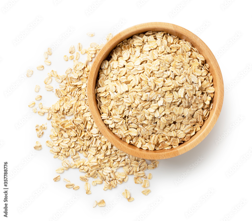 Oatmeal in a wooden bowl set against a white background. Oatmeal in a wooden bowl set against a white background.