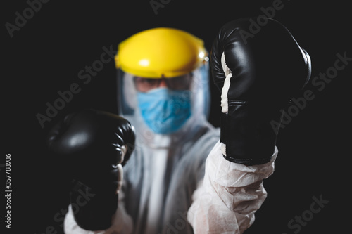 Doctor / surgeon / scientist with boxing gloves ready to fight the virus and illness.