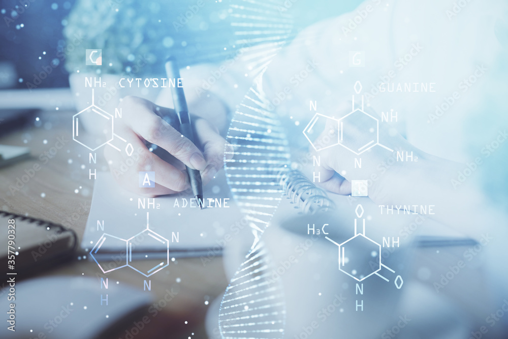 DNA theme hologram over woman's hands writing background. Concept of education. Double exposure DNA theme hologram over woman's hands writing background. Concept of education. Double exposure