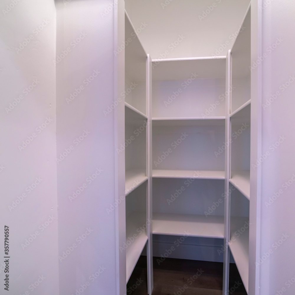 Fototapeta premium Square Empty interior of a walk-in wardrobe interior