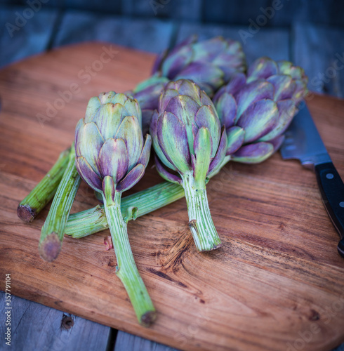Fresh Artichokes from the graden on a wooden choppingboard
