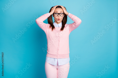 Portrait of worried girl look exam graduation schedule impressed touch hands face wear pastel sweater isolated over blue color background