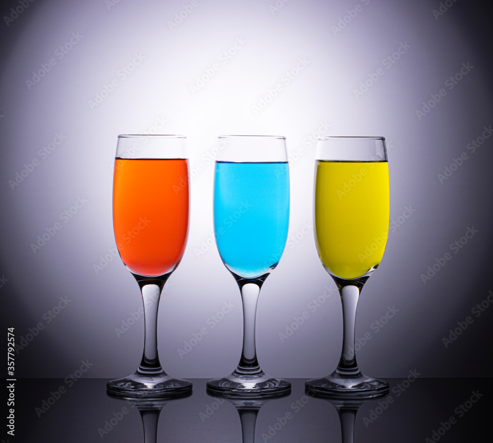 Colored wines in champagne glasses on a beautiful diffuse background