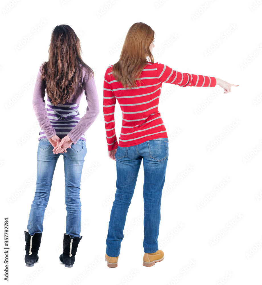 Back view of two pointing girl in sweater. Back view of two pointing girl in sweater.