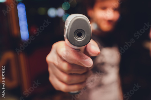 Body thermometer In the hands of men For temperature measurement in restaurant. selective focus. photo