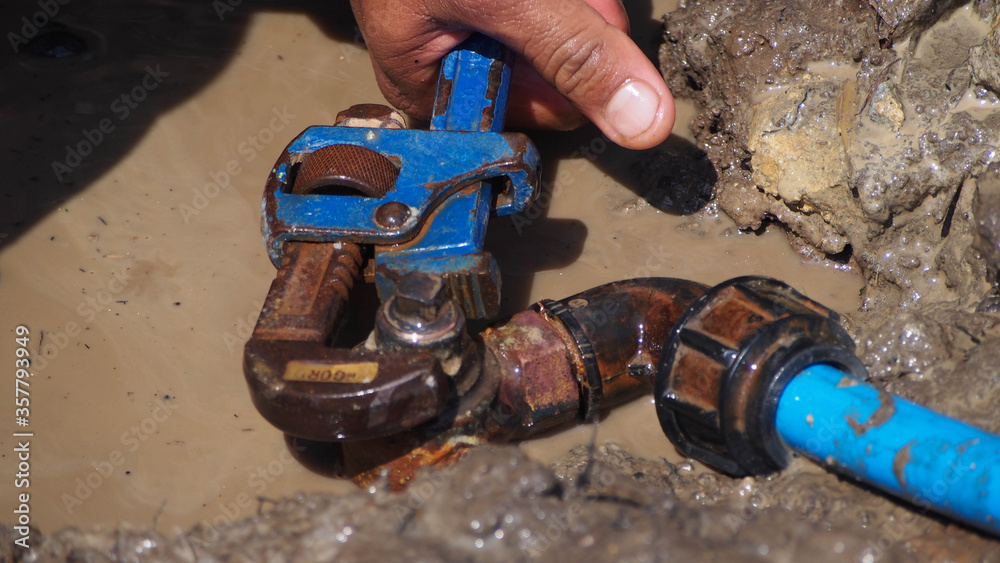 Leaking pipe on ferrule connection is being repaired Stock Photo