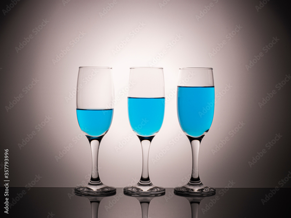 glass glasses with blue wine on a beautiful gradient background glass glasses with blue wine on a beautiful gradient background