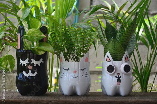 Recycled colored flower pots made of used plastic bottles. Nice decoration for inside and outside.