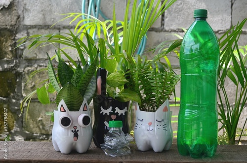 Recycled colored flower pots made of used plastic bottles. Nice decoration for inside and outside.