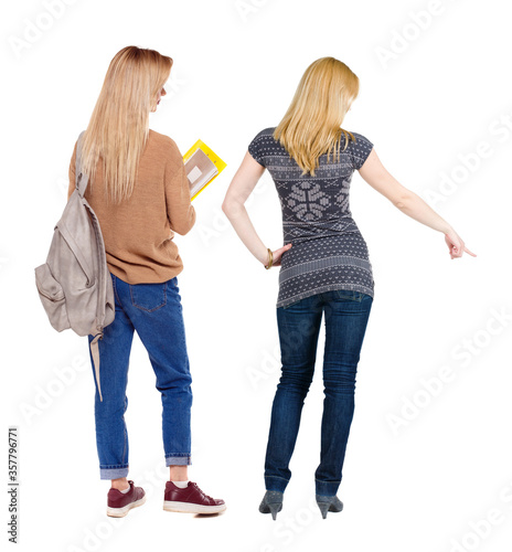 Back view of two pointing girl in sweater.