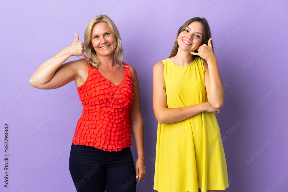 Mom and daughter isolated on purple background making phone gesture. Call me back sign Mom and daughter isolated on purple background making phone gesture. Call me back sign
