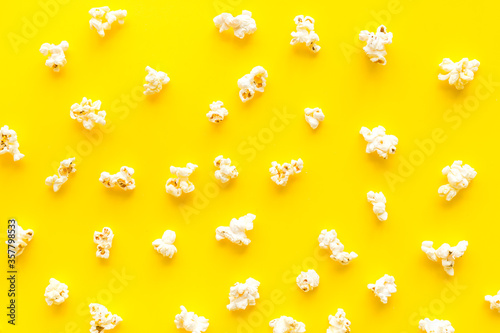 Popcorn texture on yellow background top view