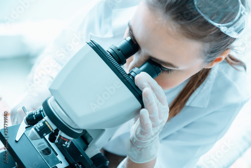 Laboratory Research Scientist Working With Microscope Testing Equipment in Lab  Professional Female Scientist Analyzing Genetic Disease on Microscopes in Clinic Lab. Medical Healthcare Biology Science