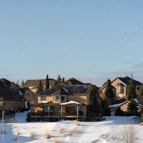 Square Vast gray sky over homes on the snowy slope of Wasatch Mountains in winter